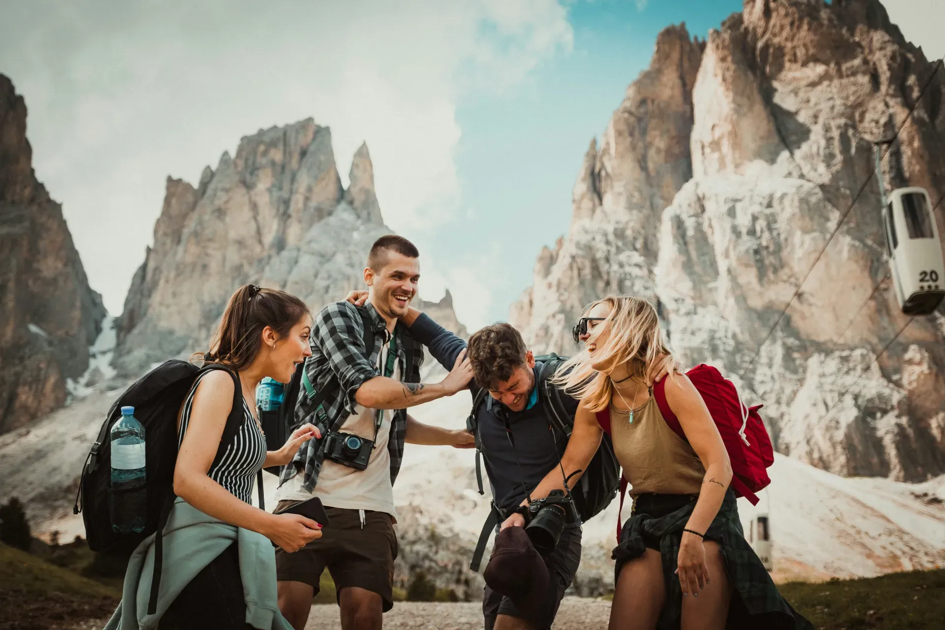 Group of friends laughing together while hiking in the Dolomite mountains