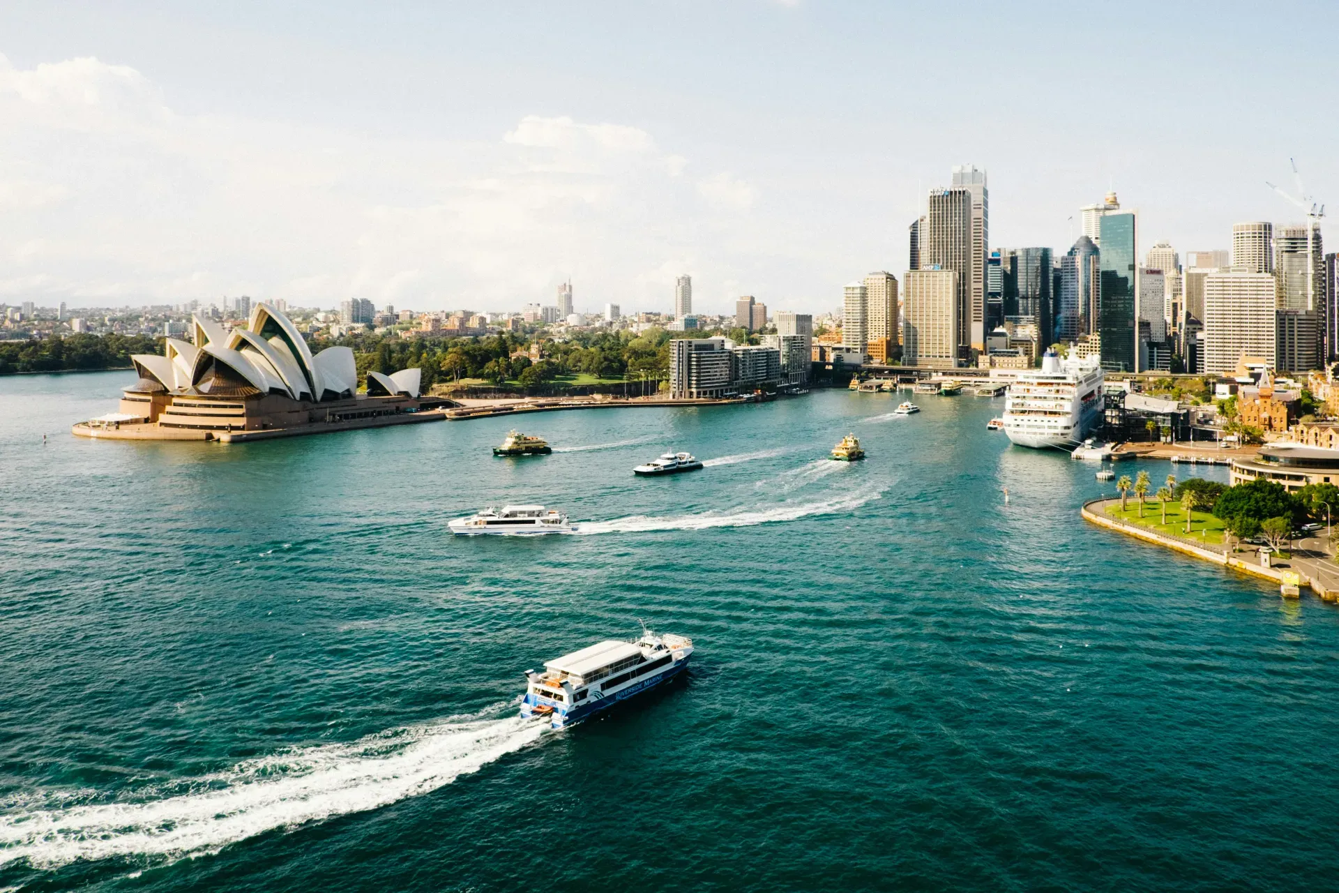 Sydney Harbour with the Opera House, city skyline, and ferries crossing the water